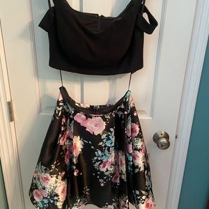 Two piece dress, black off the shoulder top with a short flowered skirt.